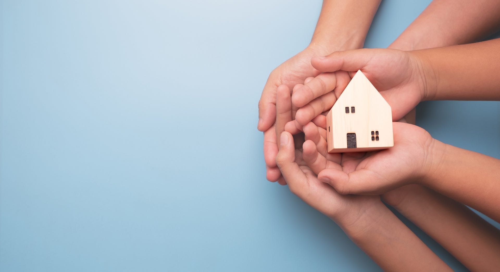 Hands holding wooden house model, real estate, Real estate broker, insurance or loan real estate, business house investment idea, family home, Homecare, renovation concept, housing and mortgage crisis